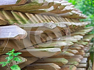 Pile of rough wood boards for rural wood fence.