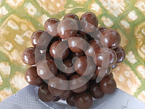 pile of round chocolates in a plastic bottle