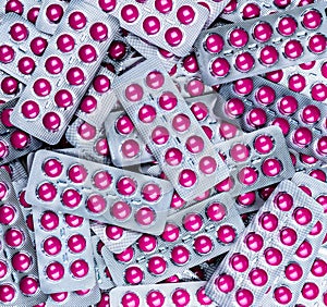 Pile of round pink tablets pill in blister pack. Pharmaceutical industry. Pharmacy products. Prescription drug. Painkiller