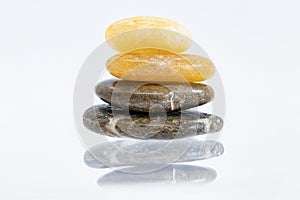 Pile of round stones from sea isolated on white background