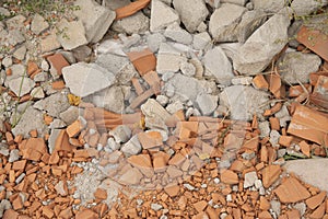 Pile of rubble and broken red bricks and cinder blocks from construction sites.
