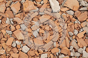 Pile of rubble and broken red bricks and cinder blocks from construction sites.
