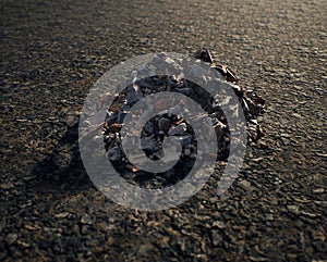 Pile of rubble on damaged tarmac.