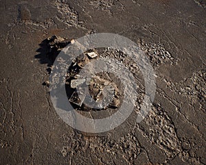 Pile of rubble on an old cracked tarmac.