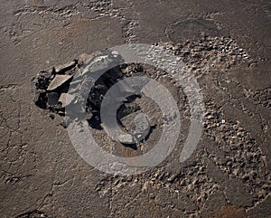 Pile of rubble on an old cracked tarmac.