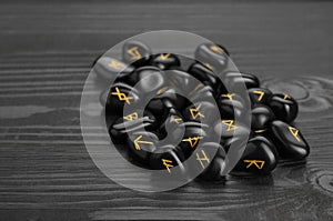 Pile of rune stones on black wooden table