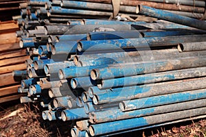 Pile of rusting scaffolding pipes