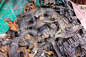 Pile of rusty and dirty obsoleted old vehicle metal engine and spare parts