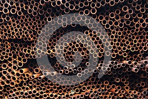 Pile of rusty metal pipes as industrial background