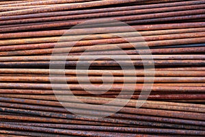 Pile of rusty metal pipes as industrial background