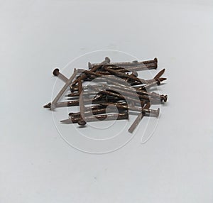 Pile of rusty nails on white background