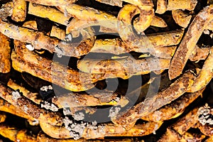 A pile of rusty obsolete chains contaminated with cement. Bright