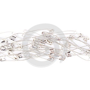 Pile of safety pins isolated on white background