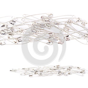 Pile of safety pins isolated on white background, set of different foreshortenings