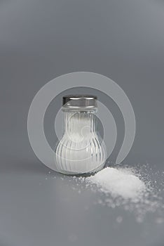 A pile of salt from salt shaker, concept excessive salt intake