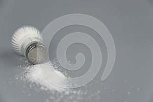 A pile of salt from salt shaker, concept excessive salt intake