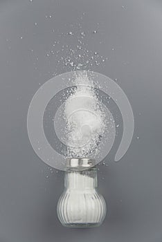 A pile of salt from salt shaker, concept excessive salt intake