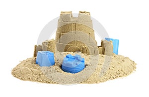 Pile of sand with beautiful castle and plastic beach toys isolated on white