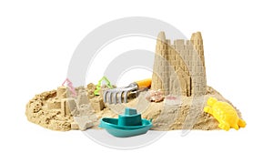 Pile of sand with beautiful castle, shells and plastic beach toys isolated on white