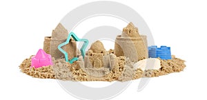 Pile of sand with beautiful castles, plastic toys and shell isolated on white