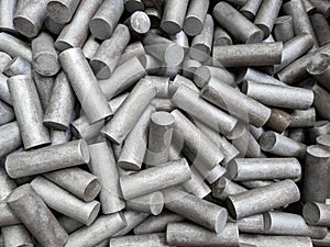 A pile of sand blasted stainless steel rods - closeup with selective focus photo