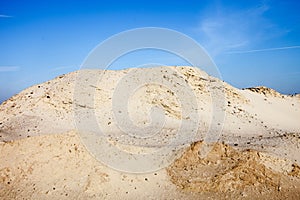 Pile of sand and blue sky over it