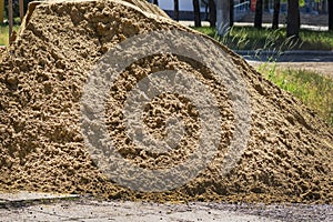 Pile of sand.Heap of sand. Loose construction material.