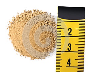 Pile of sand and measuring tape on white background, top view. Kidney stone disease