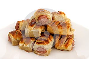 Pile of sausage rolls on a plate