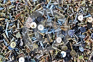 Pile of screws, abstract industrial background