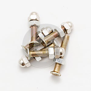 Pile of screws and nuts on white background