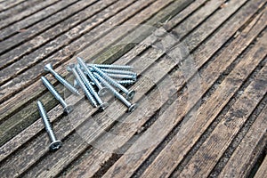 Pile of screws on wooden deck