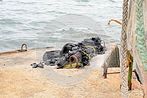 Pile of Scuba Diving Equipment Drying on Dock