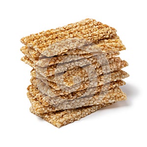 Pile of sesame snaps white background close up photo