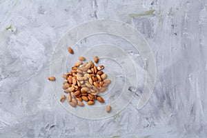 A pile of shelled almond nuts isolated against white background, close-up, top view, selective focus.