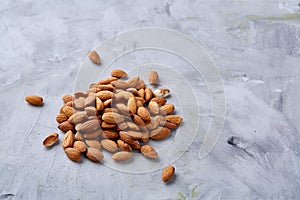 A pile of shelled almond nuts isolated against white background, close-up, top view, selective focus.