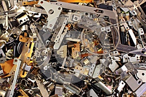 Pile of shiny metal parts. Scrap polished steel details. Abstract industrial background