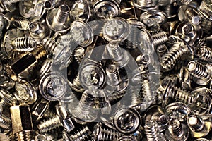 Pile of shiny metal screws, closeup image