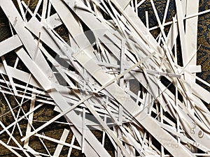 Pile of shredded photo paper after being cut, waste of white paper document, paper strips