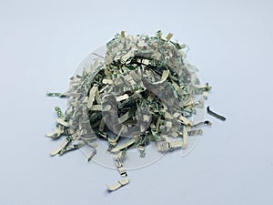 Pile of shredded United States money on white background