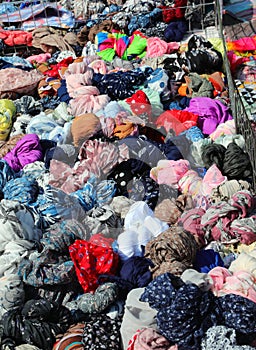 pile of silk scarves and shawls for sale in the street market