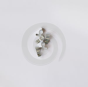 Pile of silver wire clips on white background with copy space