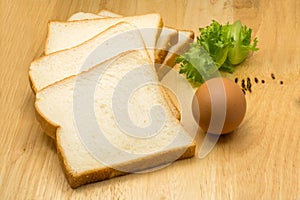 Pile of sliced bread, egg and vegetable