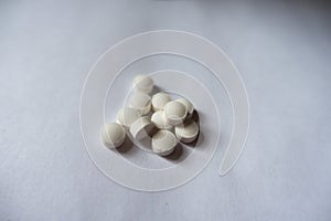 Pile of small white vitamin k tablets