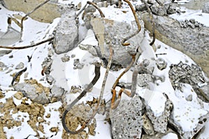 Pile of smashed asphalt rubble and rusty rebar steel