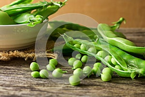 Pile of snow peas on wood background