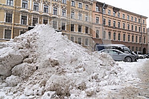 Pile snow with removed of after heavy snowfall on a city street