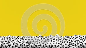 Pile of soccer balls on yellow background