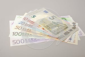 Pile of sorted banknotes on grey background