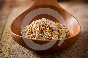 Pile of soy granules in wooden spoon
